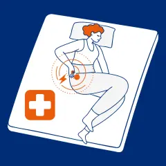 Kobieta leży na materacu, odczuwając kłujące bóle w różnych miejscach, symbolizowane przez błyskawice i okręgi. Obok niej pomarańczowy symbol krzyża.