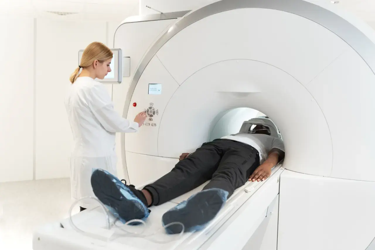 Pacjent leży w aparacie MRI, a technik kontroluje badanie. Choć rezonans magnetyczny jest bezpieczny, warto znać potencjalne skutki uboczne.
